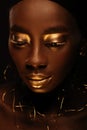 Portrait of beautiful african woman with creative gold makeÃ¢â¬âup and jewelry